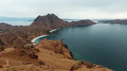 Aerial view down from the Padar island, towards boats on the coast of Komodo, Indonesia - dolly, dro