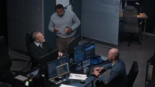 Team of Men Working on Computers in Office