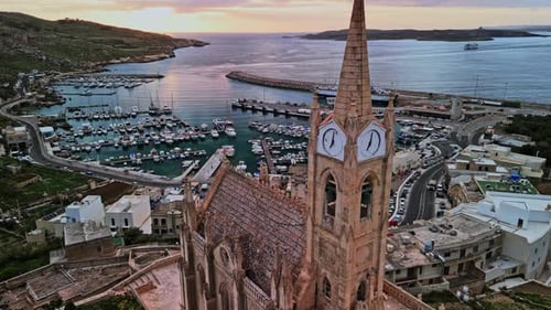 Stunning aerial view of Malta's harbor at dusk with historic architecture