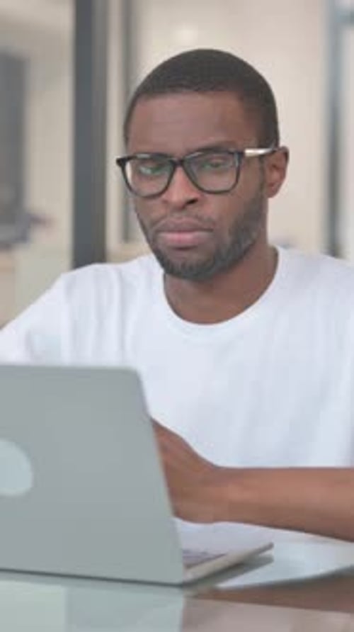 Serious African American Man Looking at Camera in Office, vertical video