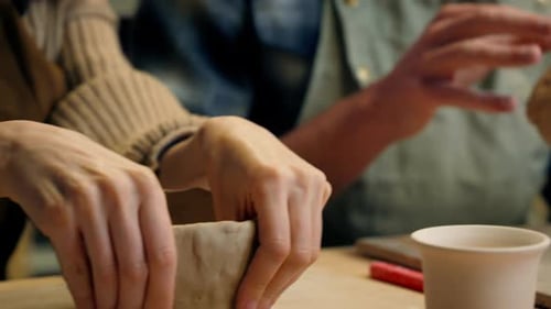 Woman Shaping Clay into Pottery Bowl in Studio