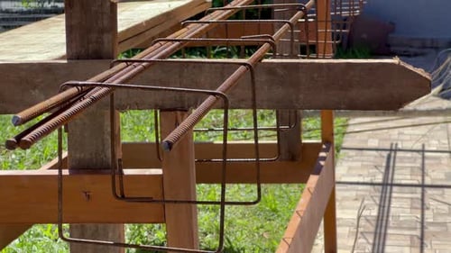 Aligned rebar and stirrups for reinforced concrete beam cage
