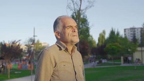 Man Walking in Park on Sunny Day
