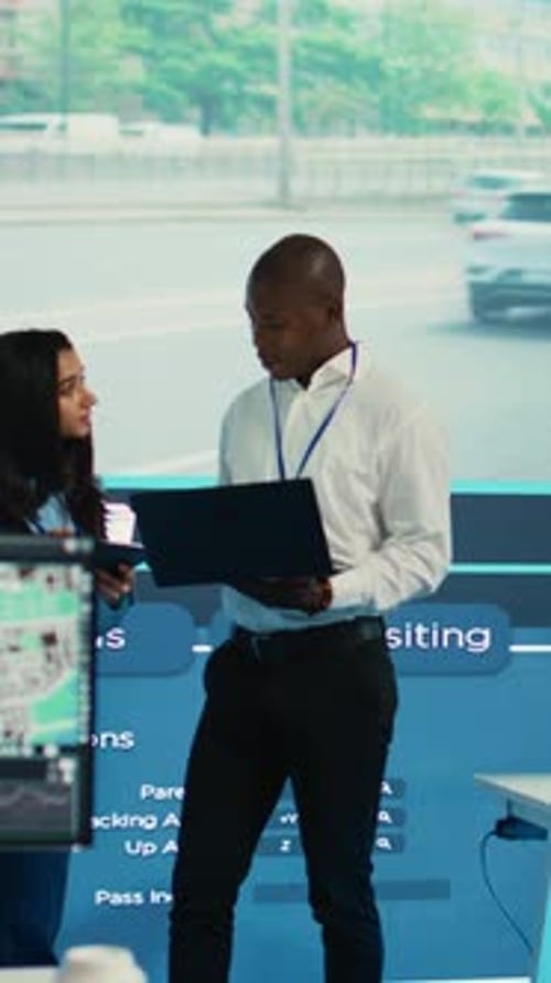 Vertical Video Team Leaders Reviewing Traffic Data Collected From Video Surveillance Footage
