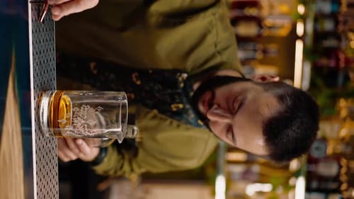 professional bartender creates a cocktail drink pours alcohol into a measuring glass at the bar