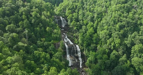 Beautiful Landscape of High Waterfall with Falling Down Clear Water From Rocky Boulders Between