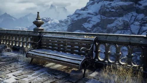 Snow Covered Bench Overlooking Majestic Mountains at Dawn Near a Stone Railing