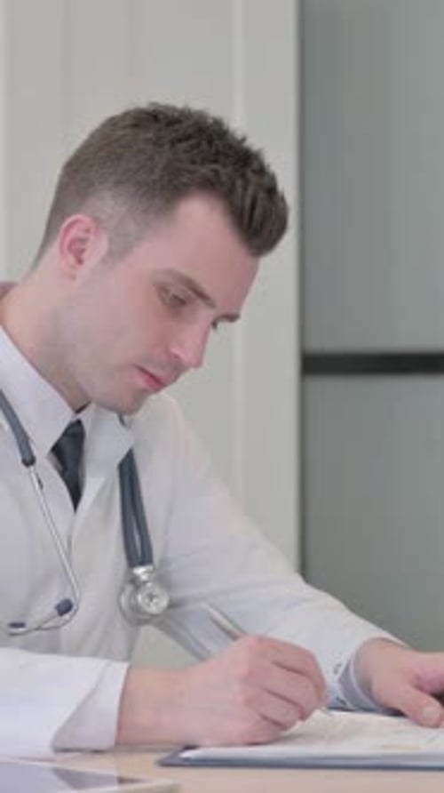 Young Doctor Working on Medical report in Clinic, Paperwork, vertical video