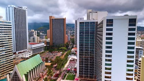 Approaching a parking lot situated among the high-rise buildings. Drone footage in Honolulu, Hawaii