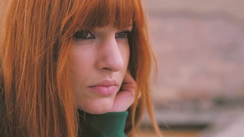 Loneliness and solitude concept: Sad depressed woman sitting outdoors