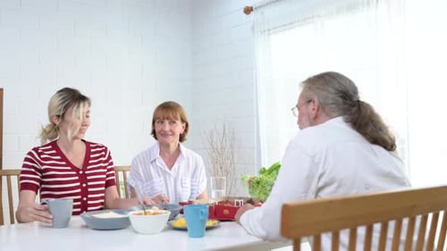 Family Eating Lunch Together in Bright Home Interior