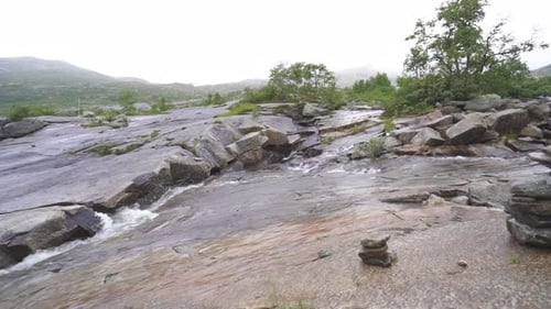 guy travels on a beautiful mountain road in norway