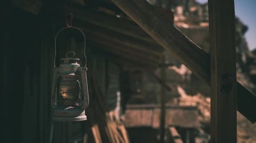 Rustic Lantern By a Cabin in a Daytime Mountain Landscape