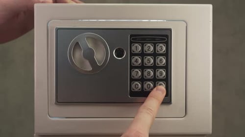 Close Up of Hand Placing Memory Card with Confidential Data Deep Inside Safe to Keep Information