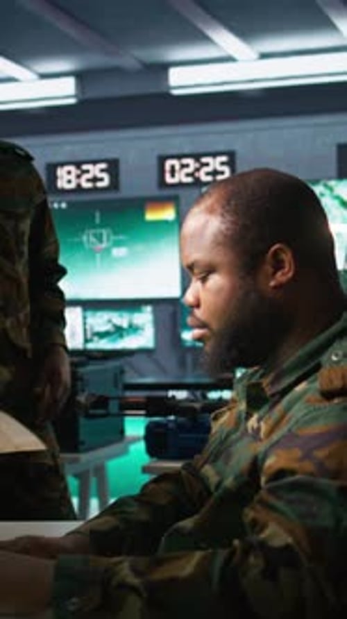 Men in Military Uniforms Collaborating in Dark Office