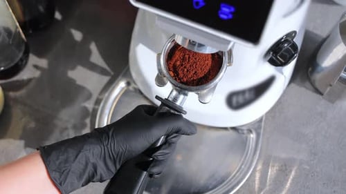 Making Coffee at Cafe With Coffee Grinder