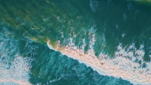 Aerial View of Turquoise Ocean Waves Crashing on Tropical Shore