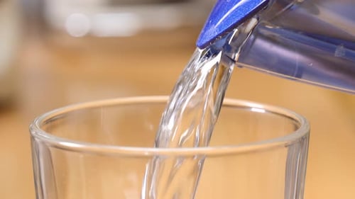 Pouring Clean Water From Filter Into Glass