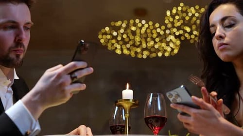 Young Couple Eating Salads in the Restaurant While Using Phones and Typing Lifestyle Love