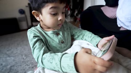 Child Concentrates While Using a Smartphone