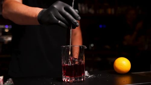 the bartender prepares a cocktail at the bar