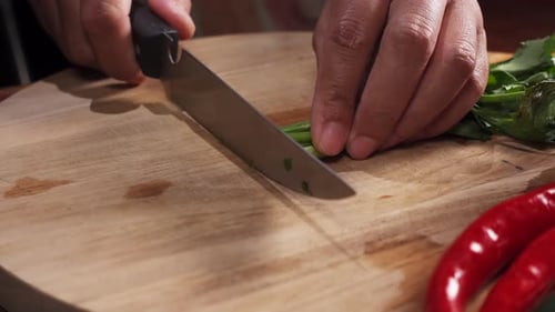 Hands Chopping Fresh Scallions on Cutting Board