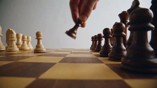 Hand Putting Brown Chess Item Making First Move on Chessboard Alone Closeup