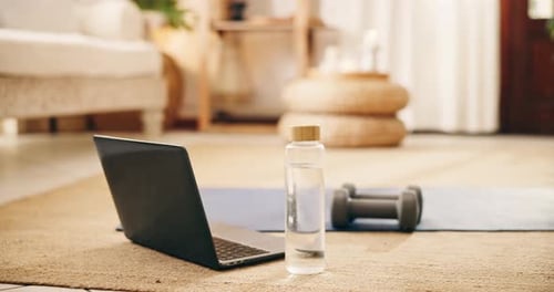 Fitness Equipment, Bottle of Water, and Laptop at Home