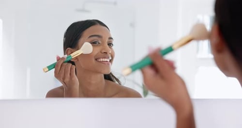 Woman Applies Makeup in Bright Bathroom
