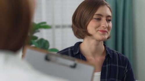 Happy patient and psychologist have mental prim conversation in clinic