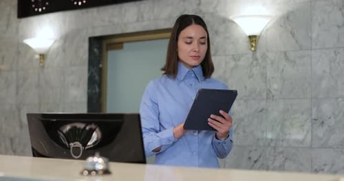 Woman Manager in Formal Outfit Holding Digital Tablet at Work in Hotel Professional Woman on Digital