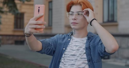 Young Adult Vlogging Outdoors With Smartphone