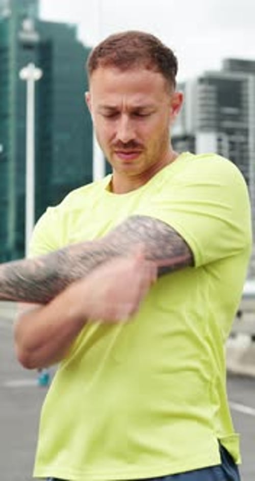 Fitness, workout and man stretching arms in city for health, wellness or training for challenge