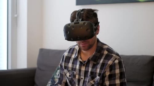 Young Adult Using Virtual Reality Headset at Home