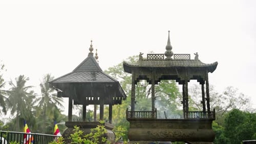 Incense Sticks Burn at Buddhist Temple with Intricate Design Smoke Rising Slowly Traditional Ritual