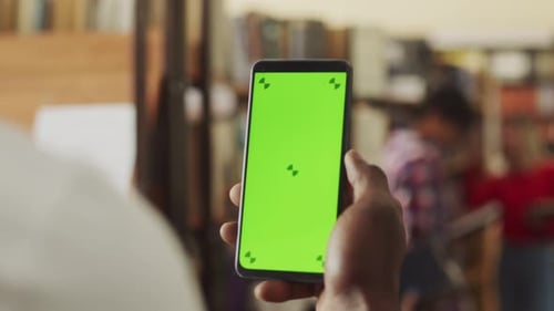 Closeup of a Person in a White Shirt Holding Smart Phone Device with a Green Screen Chromakey