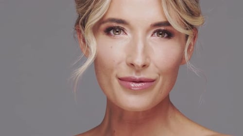 Studio Portrait of Young and Beautiful Blond Woman Over Grey Background Skin Care and Wellness