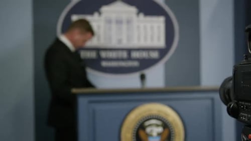 Press secretary - out of focus man approaches podium at white house HD