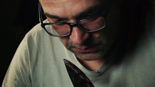 Adult With Knife Covered in Blood