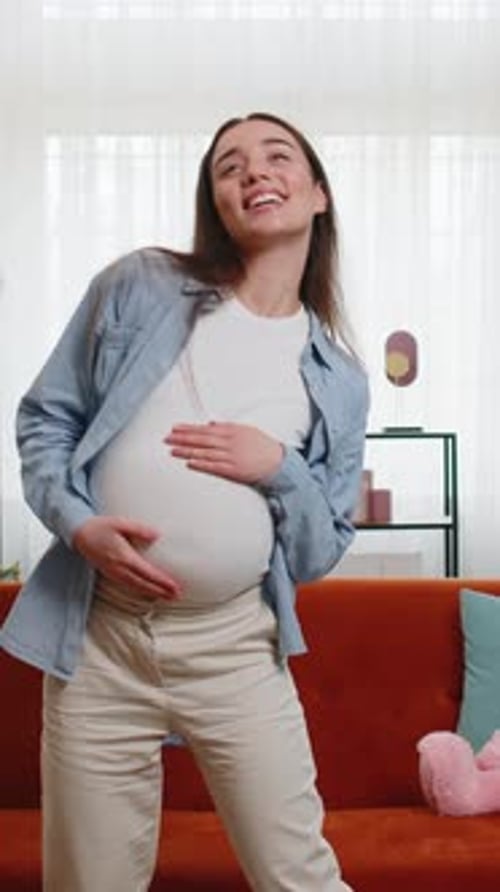 Pregnant Woman Happily Dances in Her Living Room