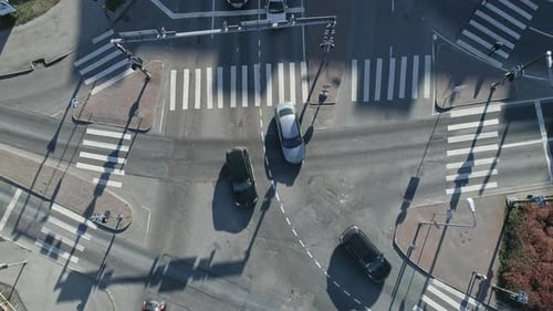 Aerial Top Down Drone Footage of Pedestrian Crossings on Urban City Intersection on a Sunny Bright