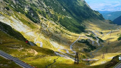 Red funicular cabin descends into the valley.