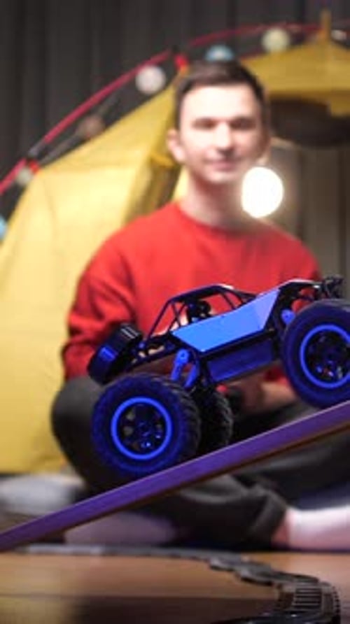 Toy Monster Truck Drives Over Ramp Indoors