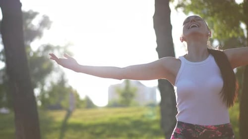 Smiling Woman Stretching After Running in Park