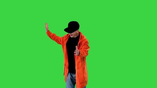 Handsome Smiling Man in Orange Parka Walking and Greeting Someone on a Green Screen Chroma Key