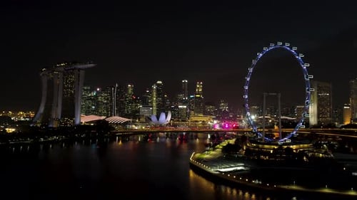 Singapore Skyline at Night with Ferris Wheel and Marina Bay Sands