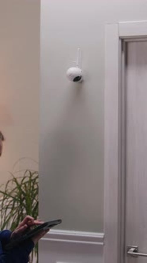 Woman Sets Up Security Camera Using Tablet