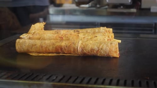 Chef Preparing Wraps on Flat Top Grill