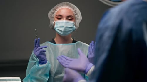 Close Up in Modern Clinic in a Bright Spacious Operating Room a Doctor a Surgeon in Sterile Gloves