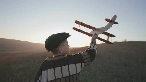 Child Runs with Airplane at Golden Hour
